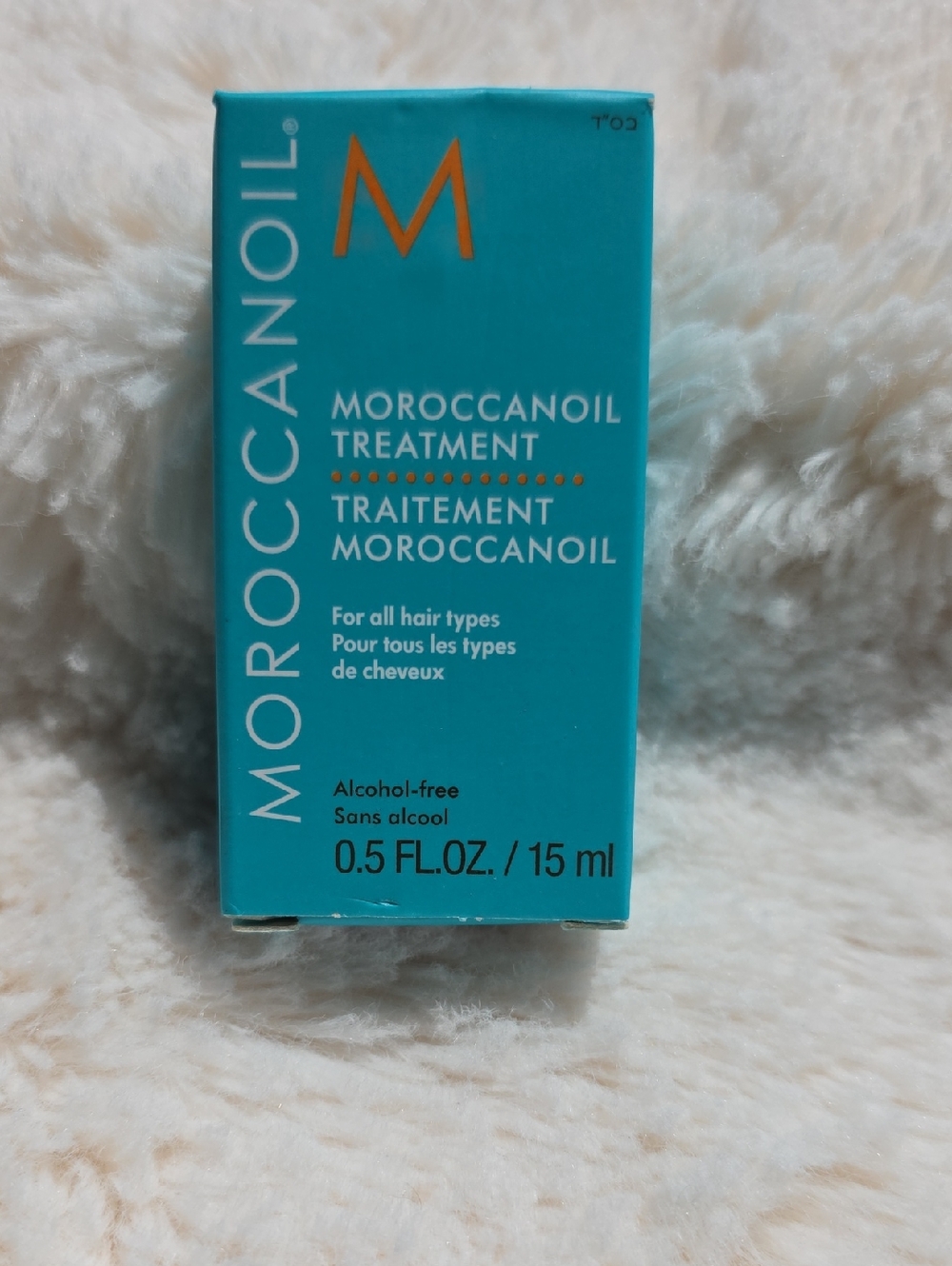 Moroccanoil Treatment in vibrant teal with orange logo